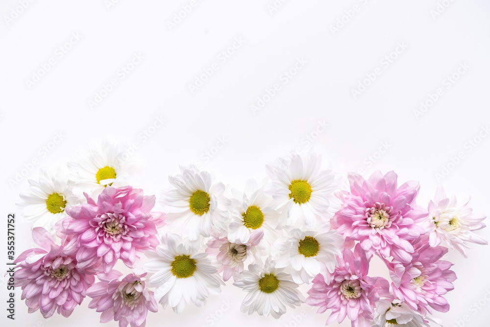 Fototapeta premium Festive flower composition isolated on the white background. Border frame. Overhead view