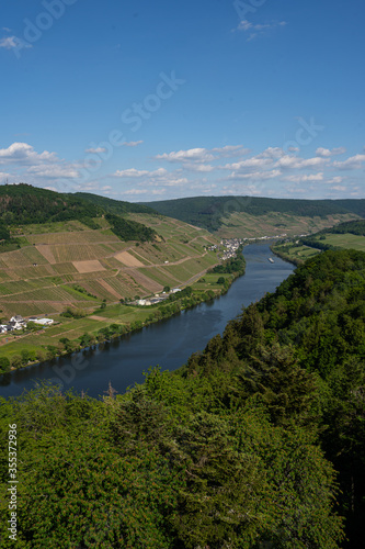 With the bike on the cycle path through the countryside along the river Moselle in Rhineland-Palatinate from Trier to Koblenz in summer