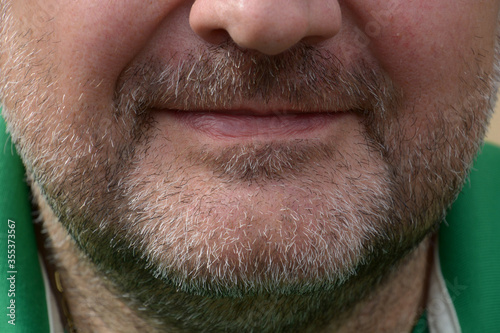 face to face shot of three-day full beard of middle aged man with narrow lips photo