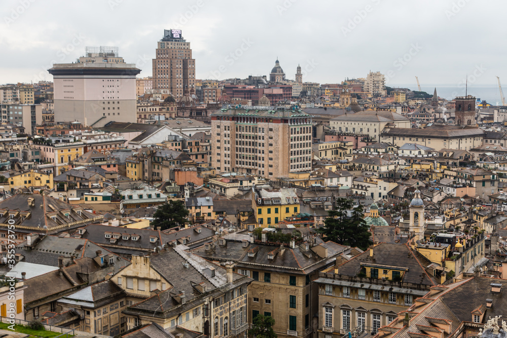 View from above of the old historical center quarter and modern districts of european city Genoa