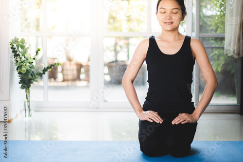 A woman in black is meditating to relax. Let go of the chaos Calm your mind 