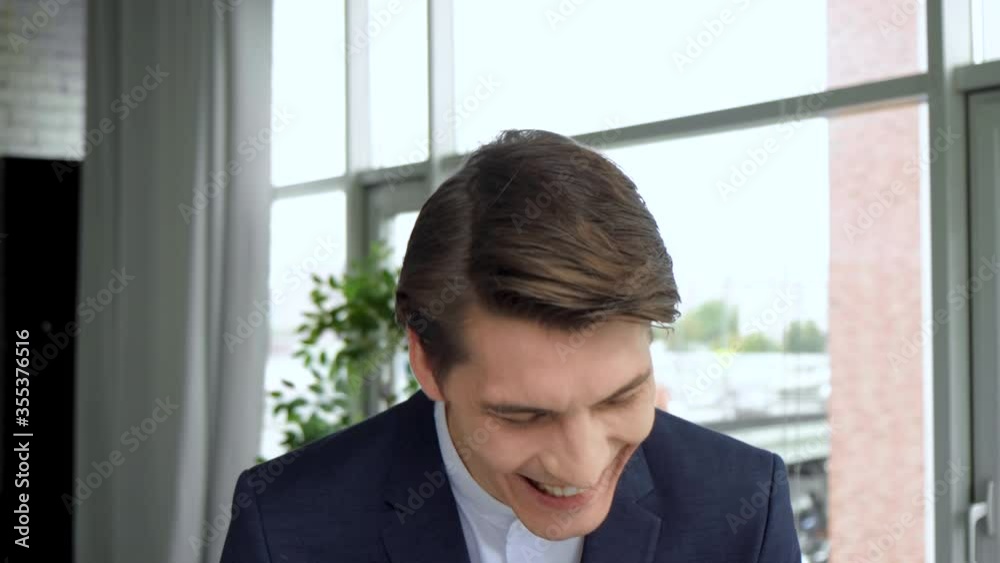 Cheerful guy smiling and looking to camera. 4k Handsome european man with trendy hairdo studio background. Cheerful guy smiling and looking to camera. 4k Handsome european man with trendy hairdo studio background.