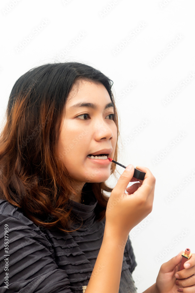 Close up face of attractive young woman applying lip cream or lip gloss Close up face of attractive young woman applying lip cream or lip gloss