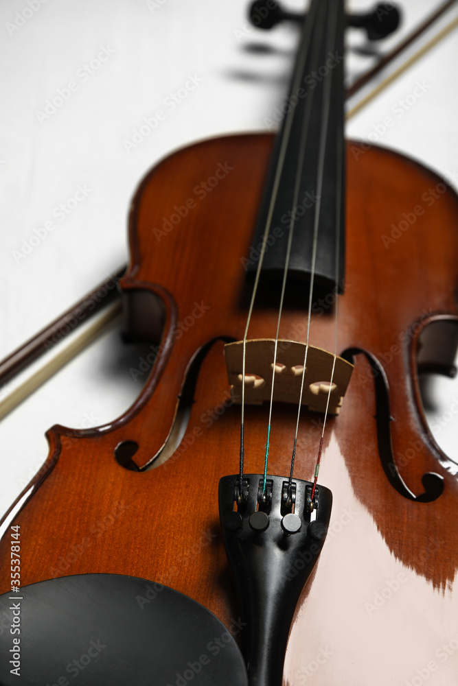 Beautiful violin and bow on grey table, closeup Beautiful violin and bow on grey table, closeup