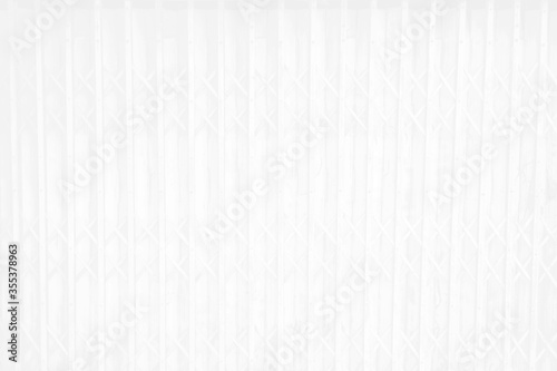 Old folded steel door, the white surface gives an old and beautiful feeling. Soft white vertical metal door surface is an old gray white iron wall. Abstract for the background.