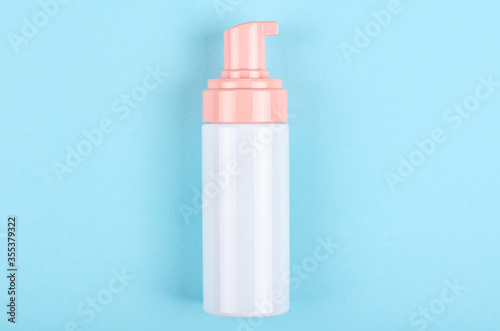 Hand sanitizer bottle on blue background.