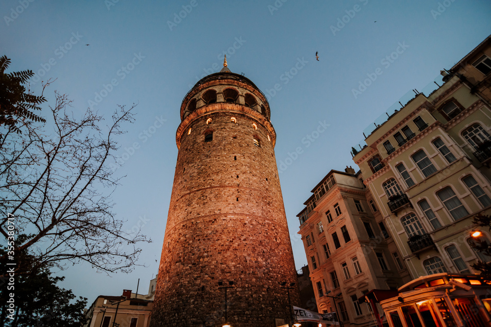 Galata Tower and a narrow vintage street in Istanbul, Turkey.