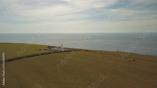 Lighthouse in green fields , shoot by drone