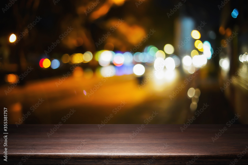 Empty wood table night street with bokeh background.