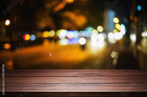 Empty wood table night street with bokeh background.