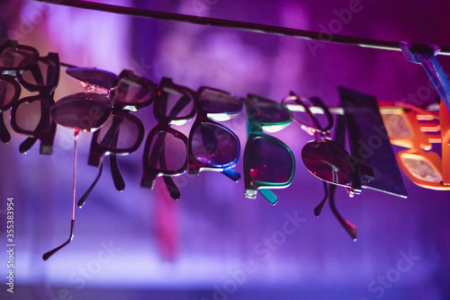 Party glasses, sunglasses on a string at a nightclub, bar at a crazy party. Rave party. Soft focus photo