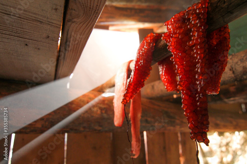 Yukon Territory, Alaska. Salmon fillet and salmon roe being smoked in a traditional wooden cabin.