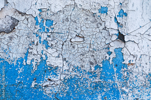 Old peeling blue painted wall. Close up