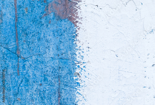 Old peeling blue painted wall. Close up