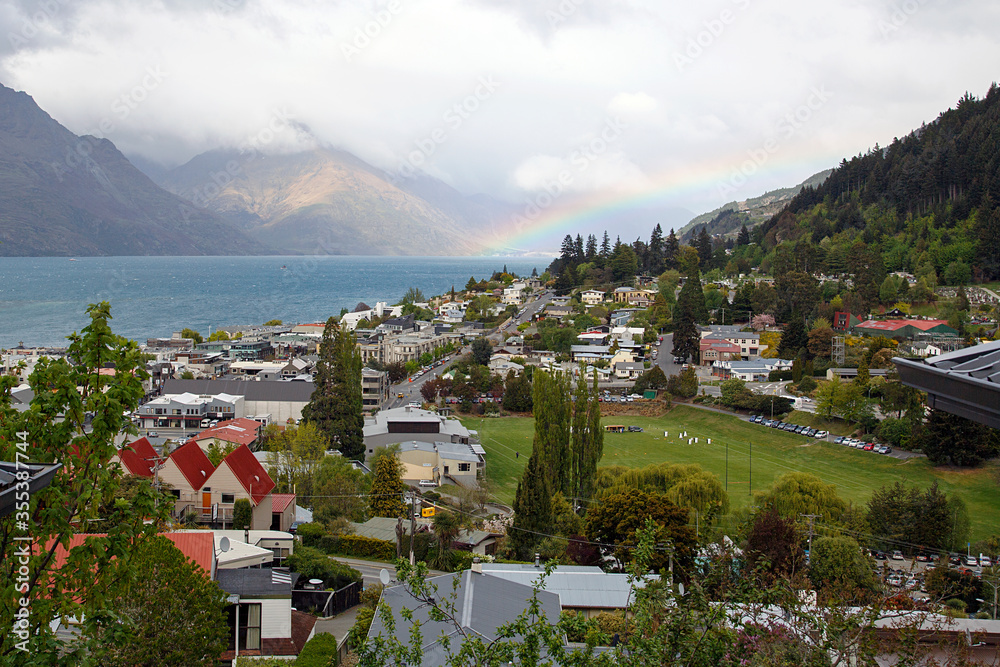 Queenstown and Lake Wakatipu with a rainbow over the route 6 leading to Glenorchy.