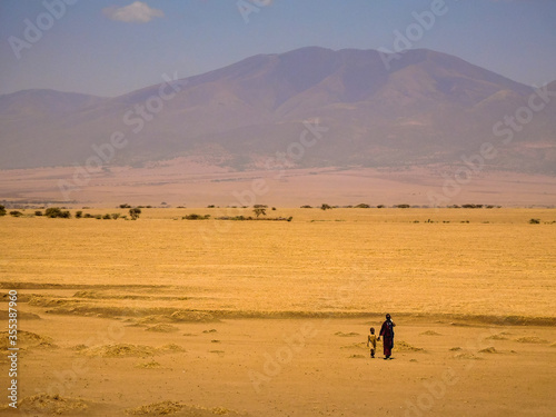 Mother and daughter walking in the desert