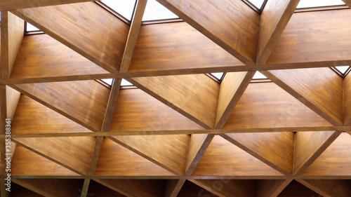 Luxurious geometric wooden triangles in construction. The concept of modern architecture, design and interior. Wood background. Modular canopy or roof.