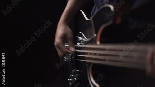4K guitarist playing an electric bass guitar photo