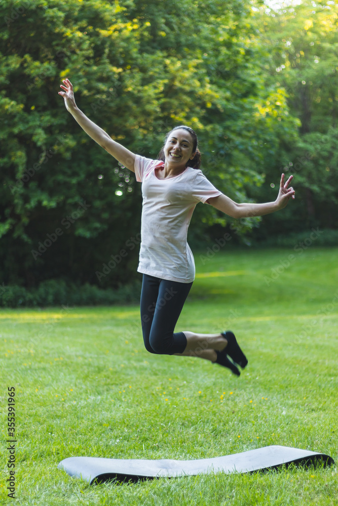 Happy, young woman jumping in the park Happy, young woman jumping in the park