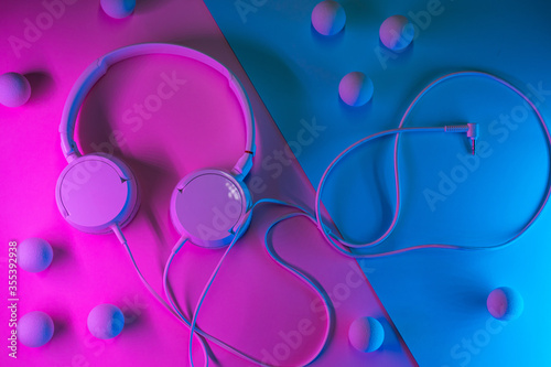 Old headphones on a colored background. Minimalism concept. photo