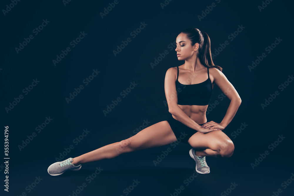Full body photo short sport suit lady doing body weight stretch active sweating after workout isolated black dark background Full body photo short sport suit lady doing body weight stretch active sweating after workout isolated black dark background