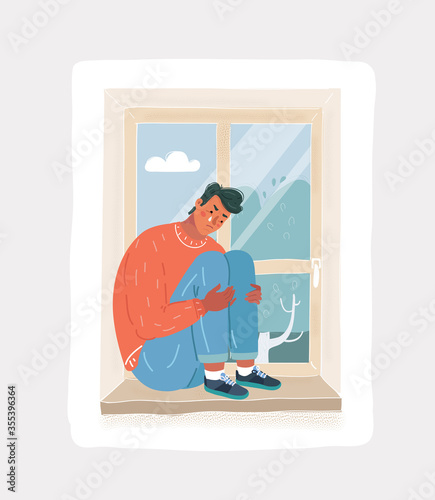 Depressed crying man sitting at the window alone feeling lonely.