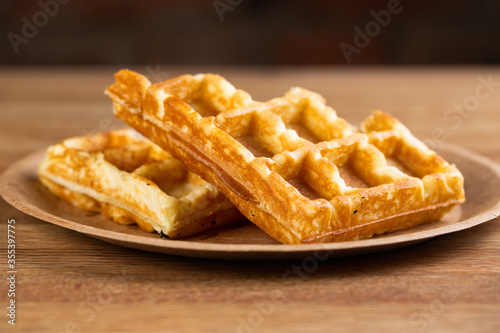 .Viennese waffles on a disposable plate with mint