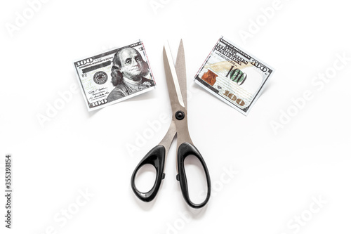 Cutting of US dollar banknote. Economic crisis concept
