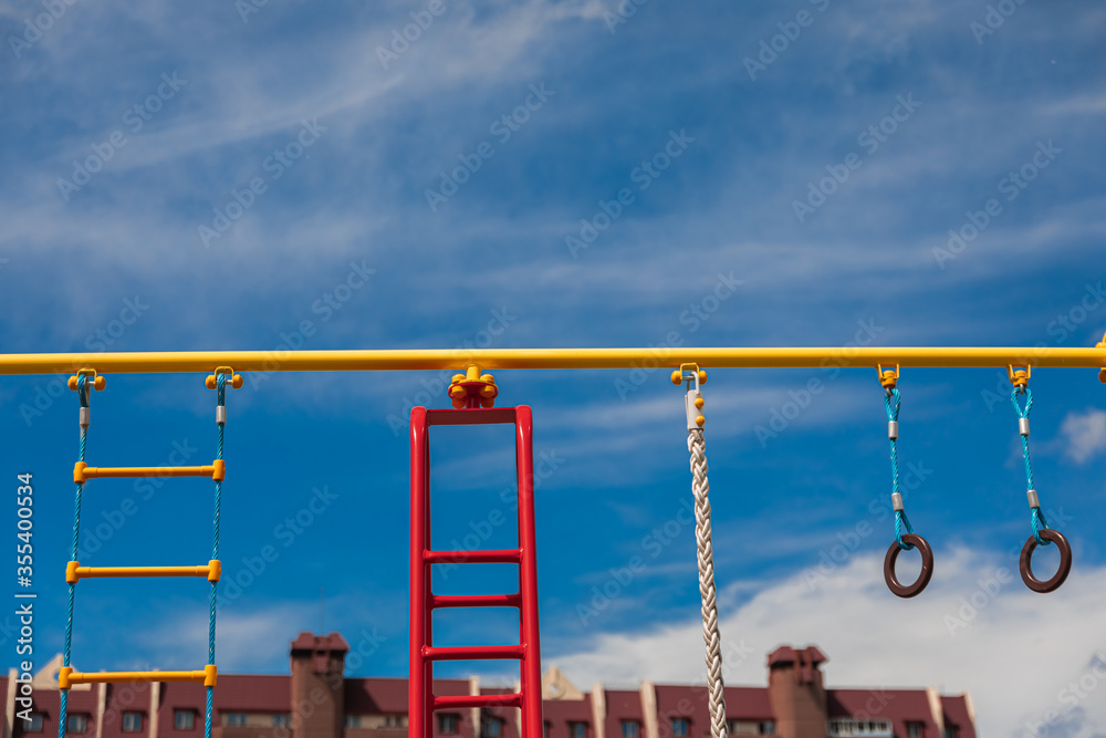 bright playground on the background of a brick house bright playground on the background of a brick house
