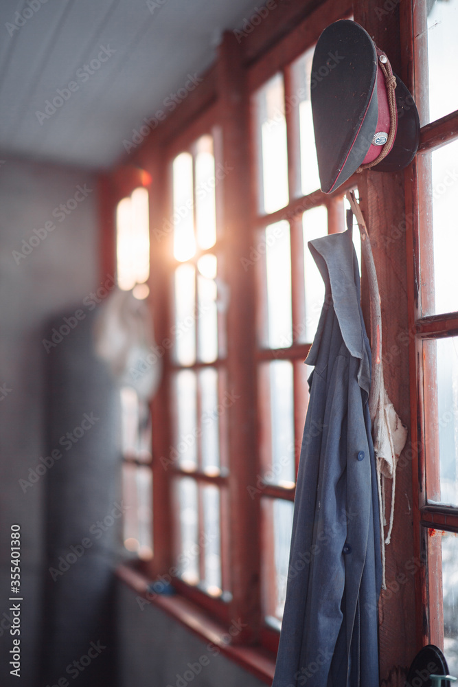 Old soviet military suit hanging on window in village.