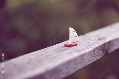 toy boat on the railing in the park, dreams of the sea and dreams of summer