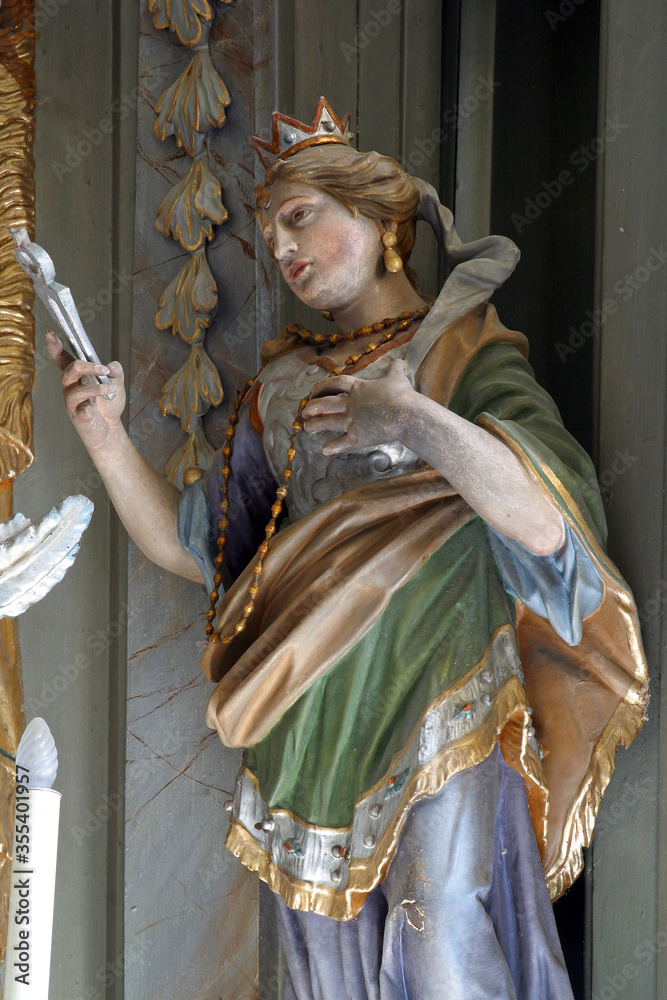 Obraz premium Saint Apollonia statue on the main altar at St. Catherine of Alexandria Church in Samarica, Croatia