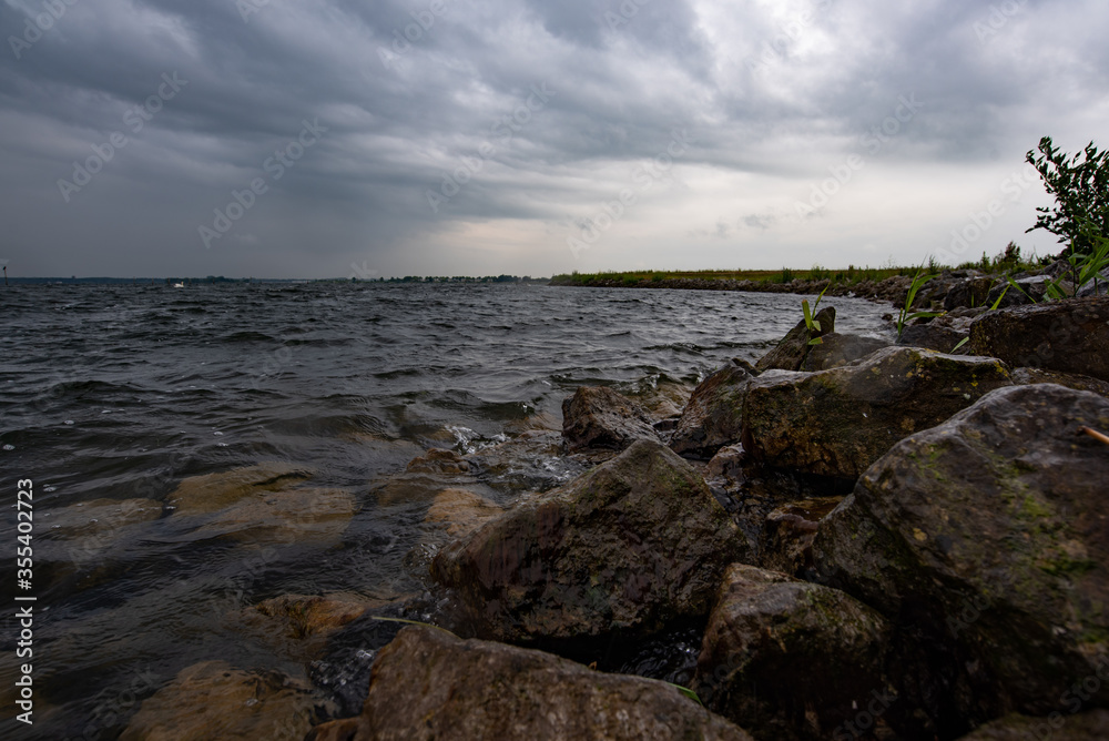 along the waterfront in Zeewolde. Dark clouds, rain. At the Tulip Island. 2020 June 5 Flevoland Netherlands.