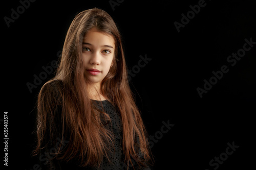Little girl with a mug on a black background.