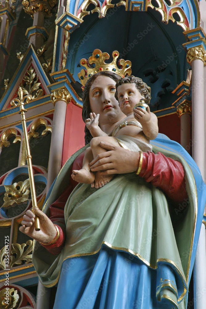 Virgin Mary with baby Jesus statue on the main altar in the parish church Birth of the Virgin Mary in Granesina, Croatia