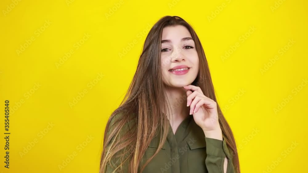 Portrait of smiling beautiful girl against of yellow background. Beauty, fashion. Cosmetics, make-up concept. Portrait of smiling beautiful girl against of yellow background. Beauty, fashion. Cosmetics, make-up concept.