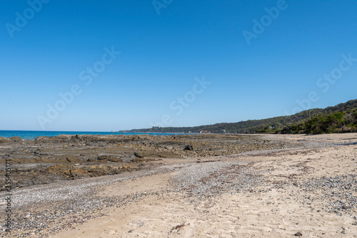 Empty Large Rocky Coastal Seaside Scene and Beach on a Sunny Day