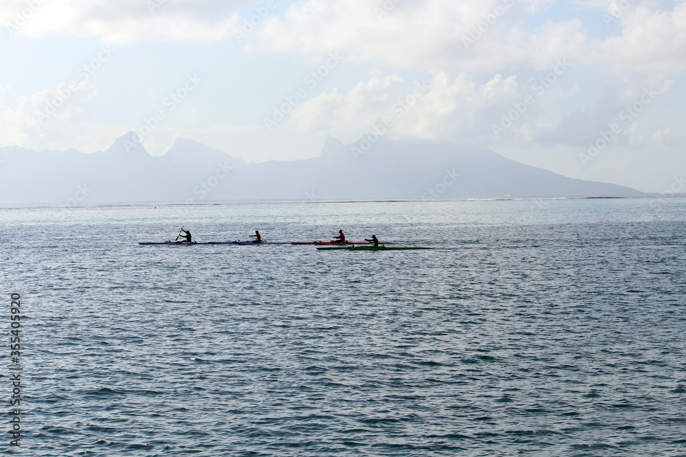 Traditional Tahiti canoe rowing in waters off French Polynesia Coast