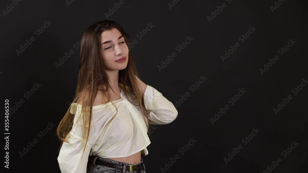 Young beautiful model posing for photographer in studio. Fashion, trendy, stylish wavy hairstyle, make up concept Young beautiful model posing for photographer in studio. Fashion, trendy, stylish wavy hairstyle, make up concept