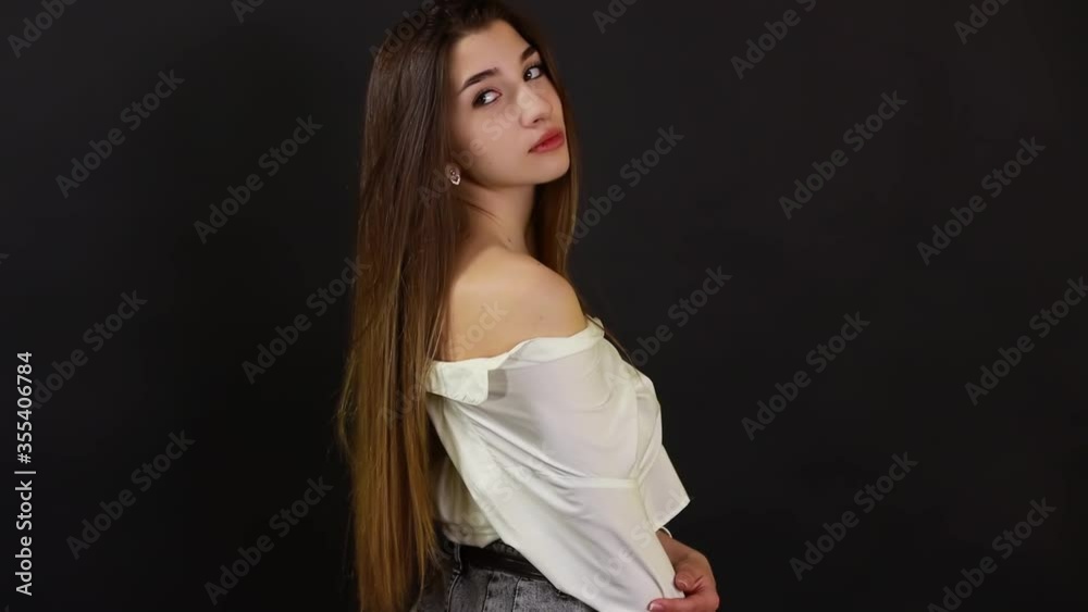 Young beautiful model posing for photographer in studio. Fashion, trendy, stylish wavy hairstyle, make up concept Young beautiful model posing for photographer in studio. Fashion, trendy, stylish wavy hairstyle, make up concept