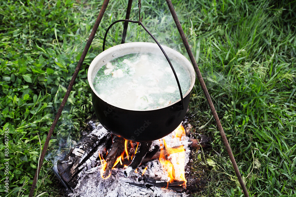 cooking on a fire in a boiler in the field cooking on a fire in a boiler in the field