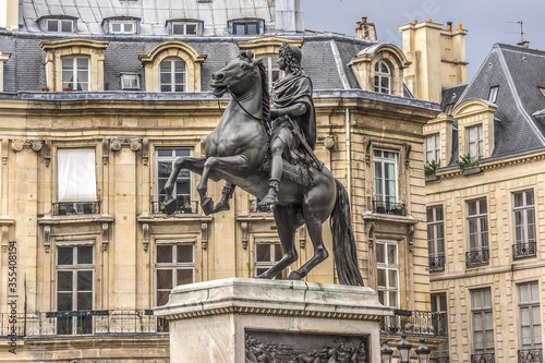 Victory Square (Place des Victoires) is a circular place in Paris, located northeast from Palais Royal. At center of Victory Square is equestrian monument of King Louis XIV (1828). Paris, France.