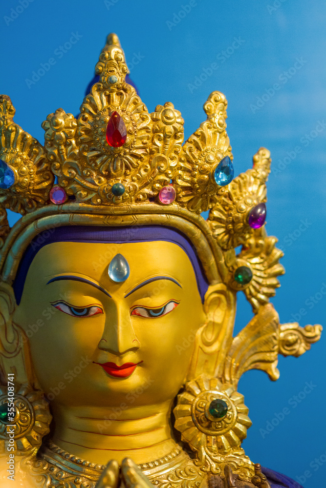 Vetrical view of gold covered statue of tibetan buddhist deity of compassion Chenrezig. Vetrical view of gold covered statue of tibetan buddhist deity of compassion Chenrezig.