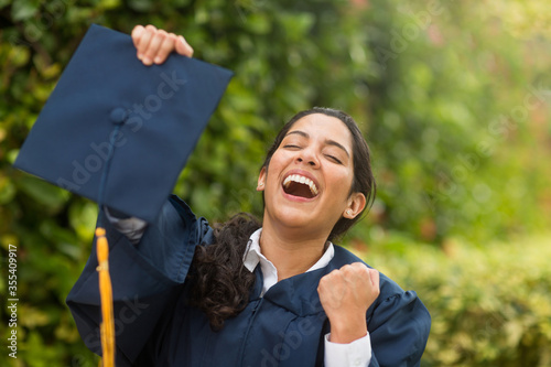 Young hispanic female graduate at her graduation photo