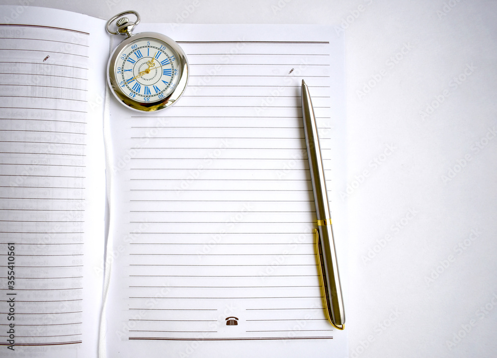 pen and watch on the notebook pen and watch on the notebook