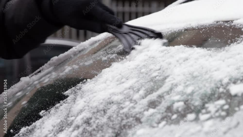 4K Close Up Slow Motion Of Scraping Snow From Front Car Glass With Scraper 4K Close Up Slow Motion Of Scraping Snow From Front Car Glass With Scraper