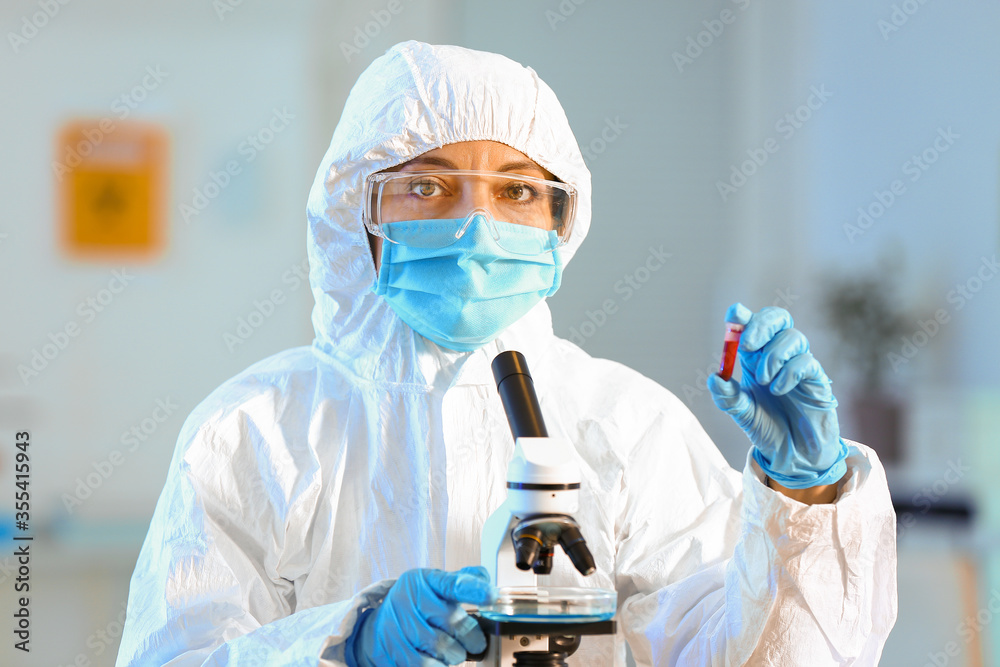 Scientist working with microscope in laboratory Scientist working with microscope in laboratory