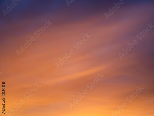 Beautiful sunset gradient from magenta sky to peachy clouds. Sunrise sky perfect for background and backdrop design. © Igor Korobko