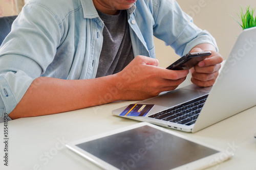 Hands holding credit card and using laptop. Online shopping