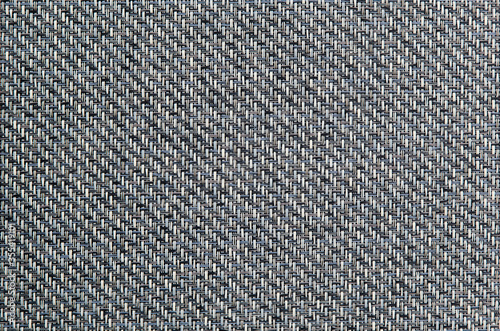 Light grey background. Geometric pattern. Woven material. Horizontal and vertical threads. Wicker decorative surface.